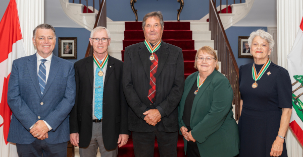 A photo of Hon. Dennis King, Premier, and Hon. Antoinette Perry, Lieutenant Governor and Chancellor of the Order, with the 2024 recipients of the Order of PEI.