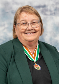 A photo of 2024 Order of PEI recipient Kathryn Dau-Schmidt wearing the Medal of Merit.